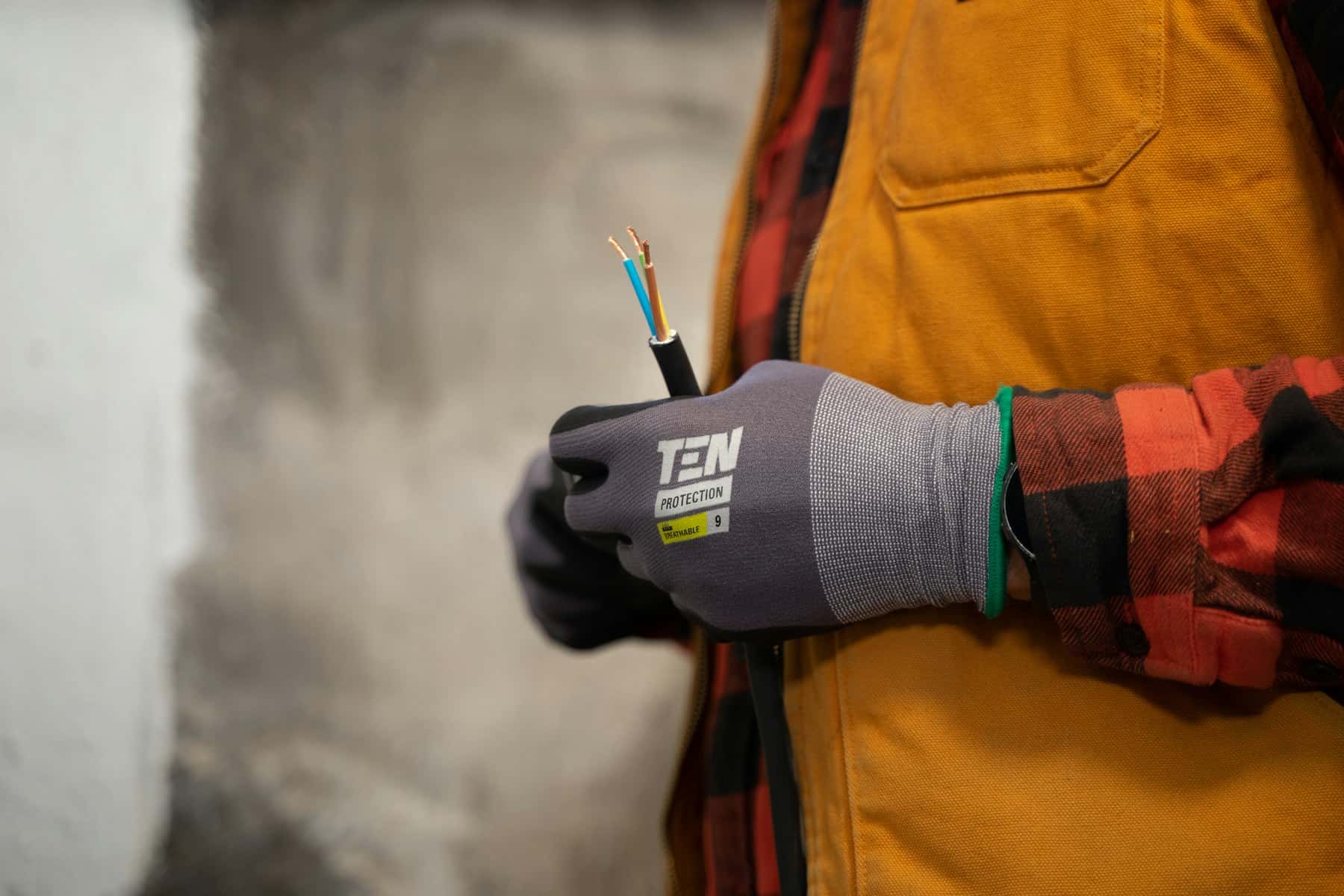 An electrician holding a bundle of wires