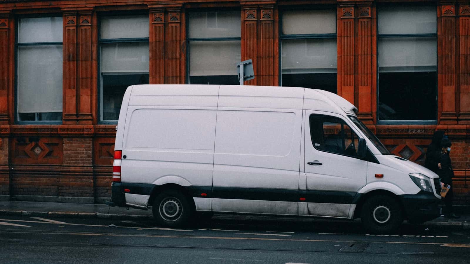 A white work van parked at the roadside