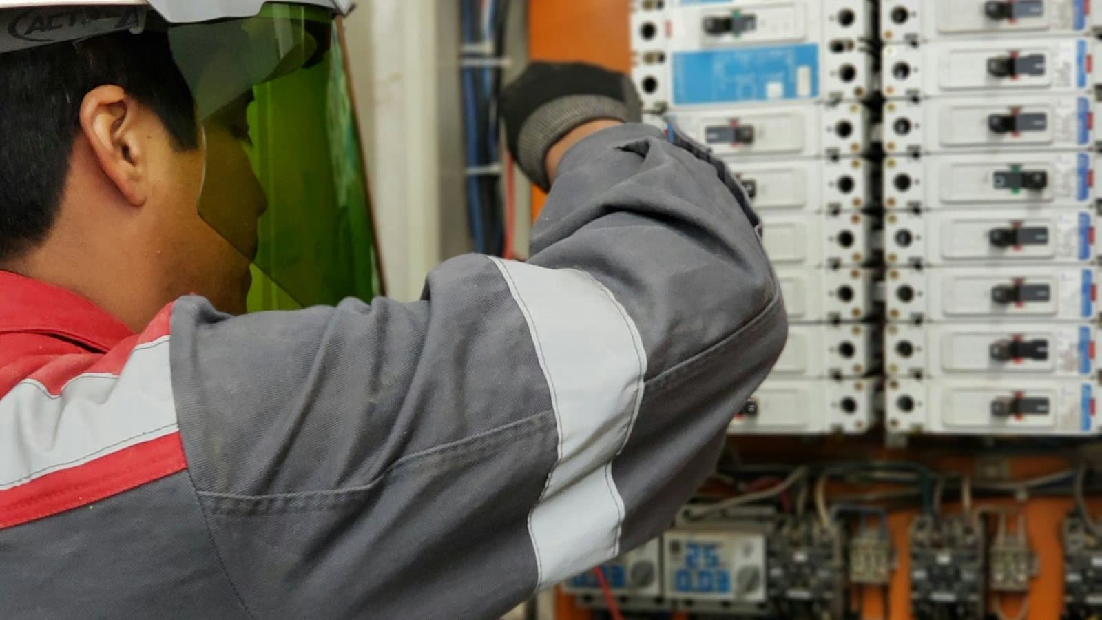 Electrician testing an electrical panel with a meter