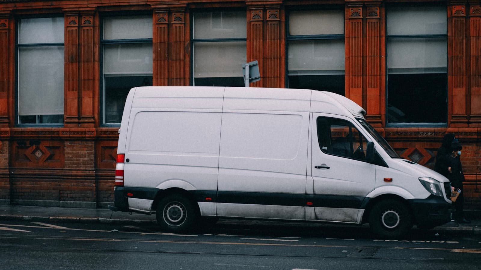 A white work van parked at the roadside
